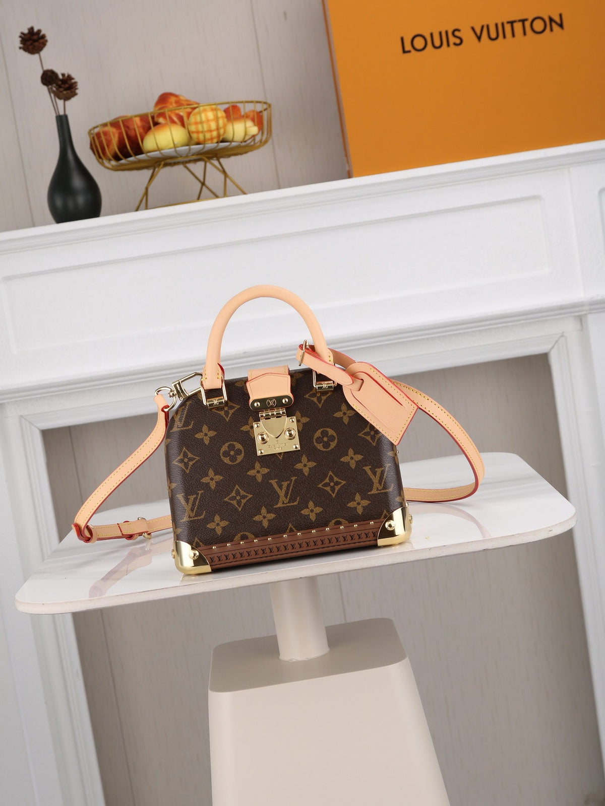 Structured monogram canvas box handbag with natural leather trim, gold-tone hardware, and convertible strap